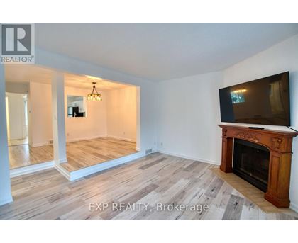A living room with a fireplace and a television.