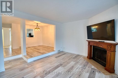 A living room with a fireplace and a television.