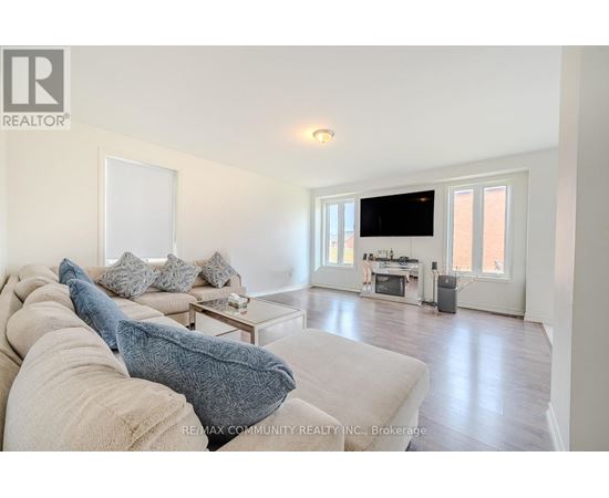 A living room with a couch and a television.