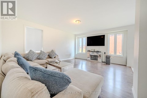 A living room with a couch and a television.