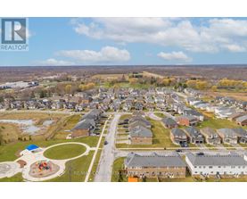 A bird's eye view of a residential community with houses and a playground.