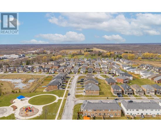 A bird's eye view of a residential community with houses and a playground.