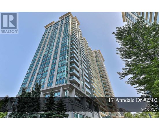 A tall building with a glass facade is located at 17 Annandale Dr #2302 in Toronto.
