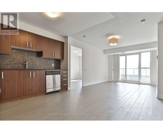 A kitchen with wooden cabinets and a stone backsplash is shown.