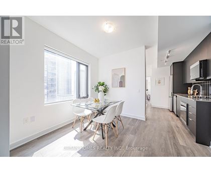 A well-lit, modern kitchen with a dining table set for four.
