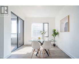 A dining room with a glass table and chairs.