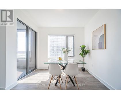 A dining room with a glass table and chairs.