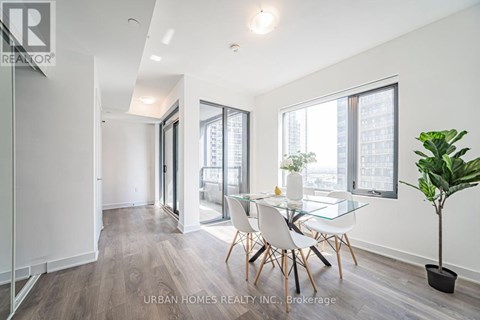 A modern living room with a glass table and chairs.