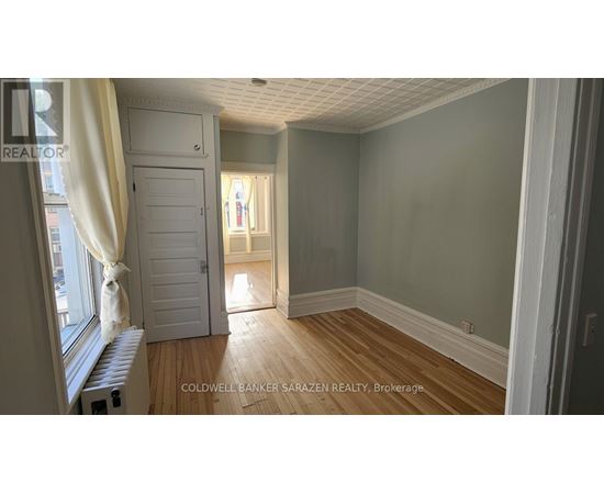 A room with wooden floors and a white door.