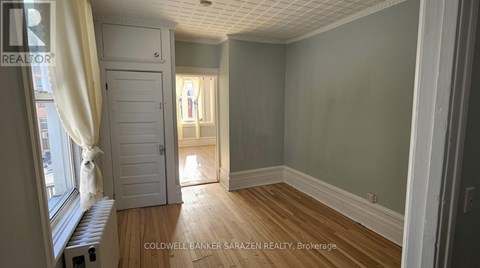 A room with wooden floors and a white door.