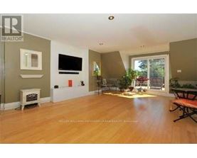 A living room with a flat screen TV mounted on the wall.