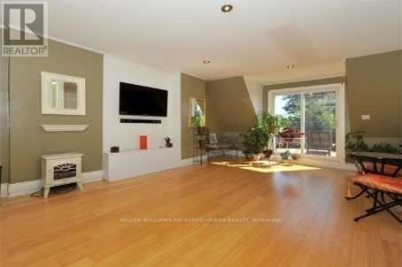 A living room with a flat screen TV mounted on the wall.