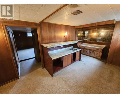 A kitchen area with a sink and a refrigerator.