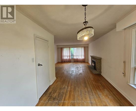 A room with a wooden floor and a chandelier hanging from the ceiling.