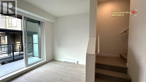 A room with a staircase leading to the second floor.