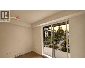 A room with a sliding glass door leading to a balcony.