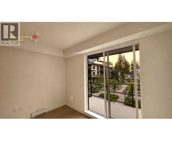A room with a sliding glass door leading to a balcony.