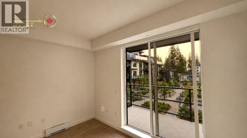 A room with a sliding glass door leading to a balcony.