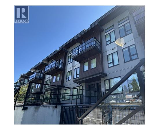 A modern building with a balcony and a Realtor logo.
