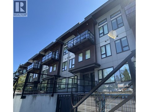 A modern building with a balcony and a Realtor logo.