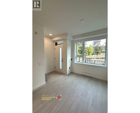 A room with a door and a window with a view of a park.