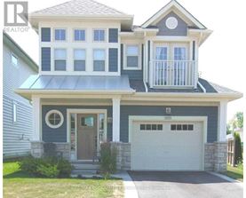 A two-story house with a balcony on the second floor.