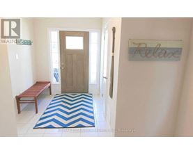 A hallway with a wooden door and a sign that says "relax".