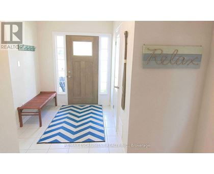 A hallway with a wooden door and a sign that says "relax".
