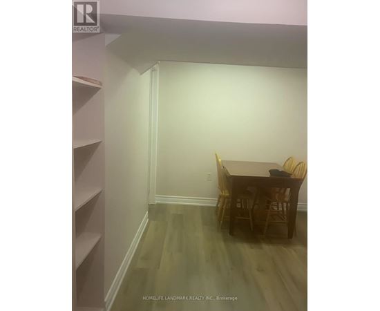 A dining room with a table and chairs.