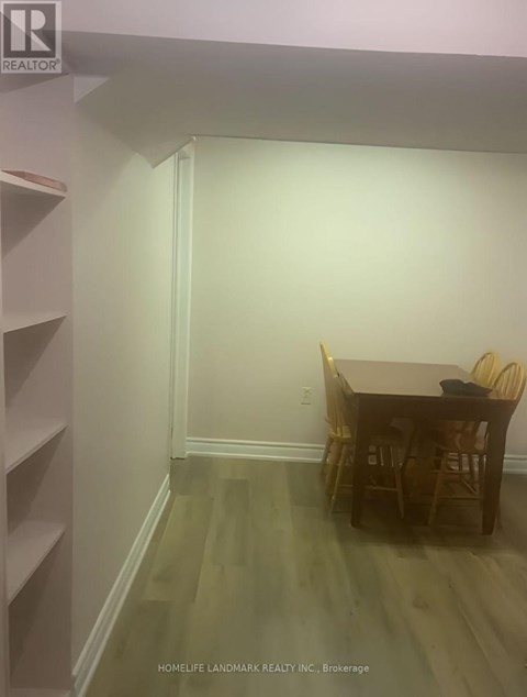 A dining room with a table and chairs.