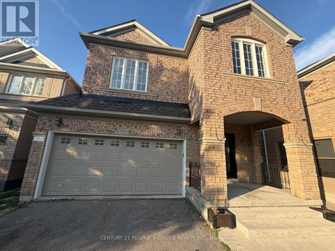 A house with a brick facade and a white garage door.
