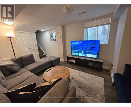 A living room with a grey couch and a wooden coffee table.
