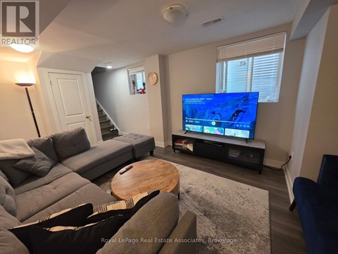 A living room with a grey couch and a wooden coffee table.