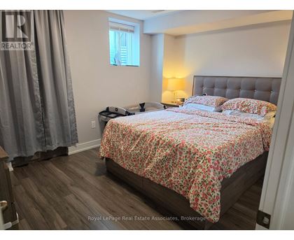 A bedroom with a bed covered in a floral print bedspread.