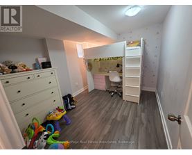 A room with a bunk bed and a desk.