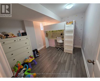 A room with a bunk bed and a desk.