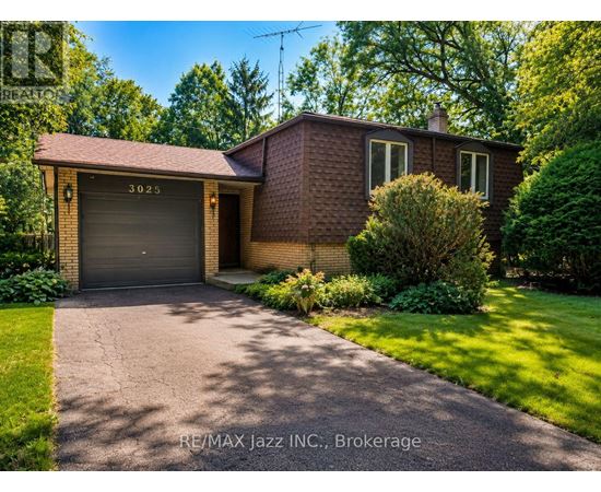 A house with a garage door numbered 3025 is for sale.