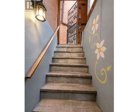 A staircase with a flower painted on the wall.