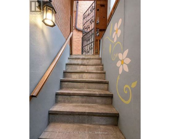 A staircase with a flower painted on the wall.