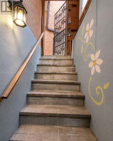 A staircase with a flower painted on the wall.