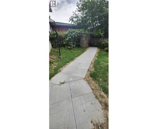 A concrete pathway leads through a grassy area.