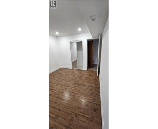 A room with wooden flooring and a white ceiling.