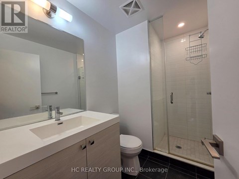 A bathroom with a sink, toilet, and shower.