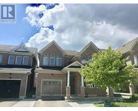 A house with a large front yard and a tree in front of it.