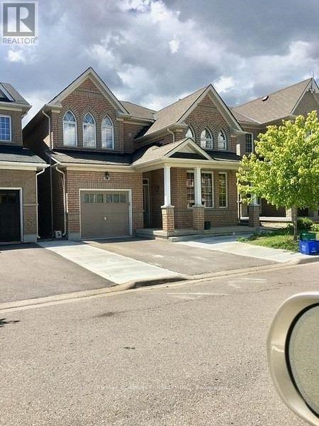 A large house with a brick facade and a large front yard.