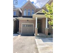 A house with a garage and a driveway in front.