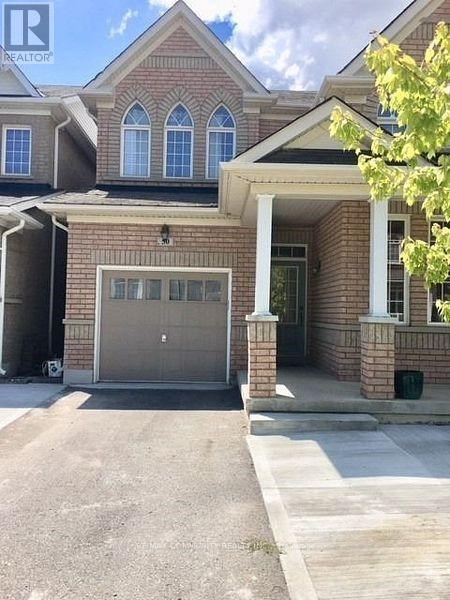 A house with a garage and a driveway in front.