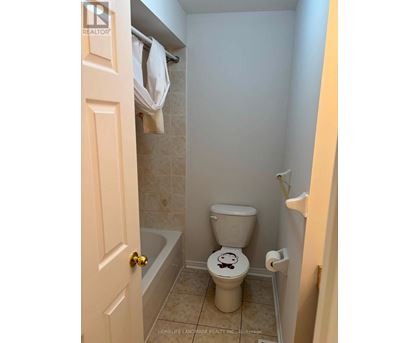 A small bathroom with a toilet and a bathtub.