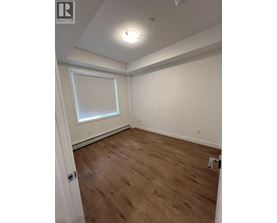 A room with wooden flooring and a window.