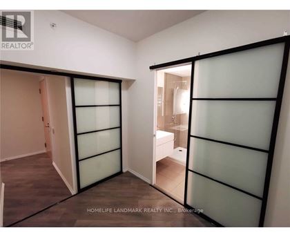 A room with a glass door and a white wall.